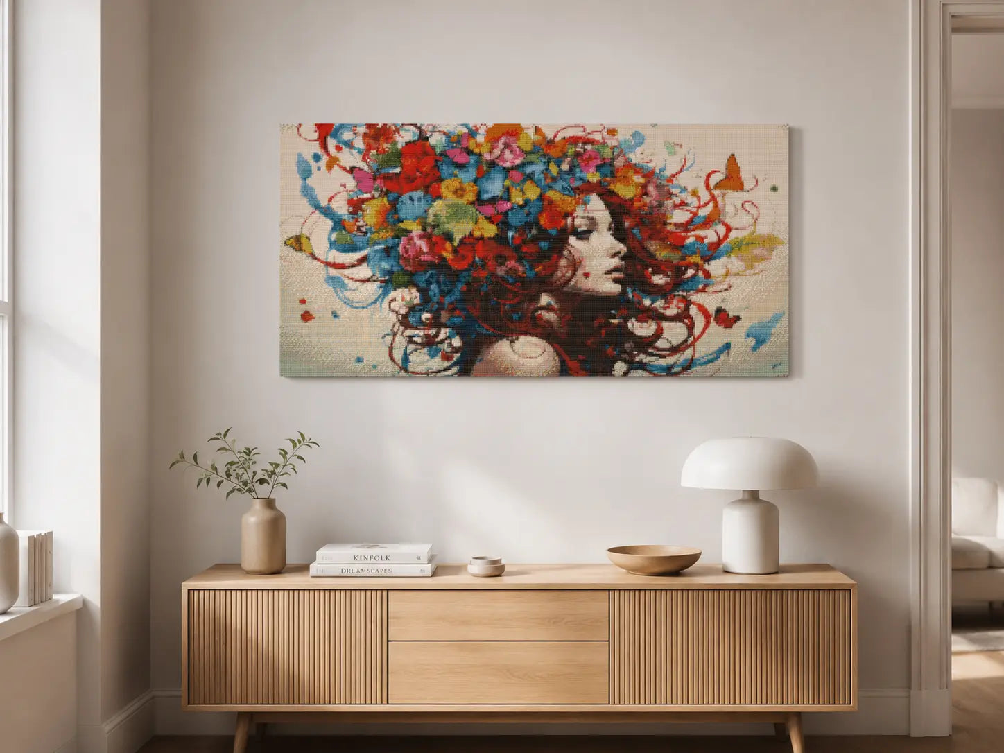 Colorful artwork of a woman with flowers in her hair above a wooden console table.Free as a Butterfly Diamond Painting Kit by Nordik Atelier 