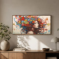 Colorful artwork of a woman with flowers in her hair on a wall above a wooden console table. Free as a Butterfly Diamond Painting Kit by Nordik Atelier
